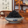 Deeply roasted Mi Lan Xiang Dan Cong dry leaves, tightly twisted, dark strips, warm sweet aroma