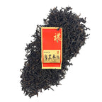 Dry tea leaves with packaging of Phoenix Oolong Tea Gongfu Tea Sachets, showing premium quality