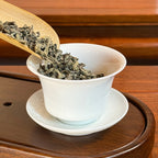 Rich Loose Leaf Green Tea Spring Harvest being prepared for brewing with Chinese food