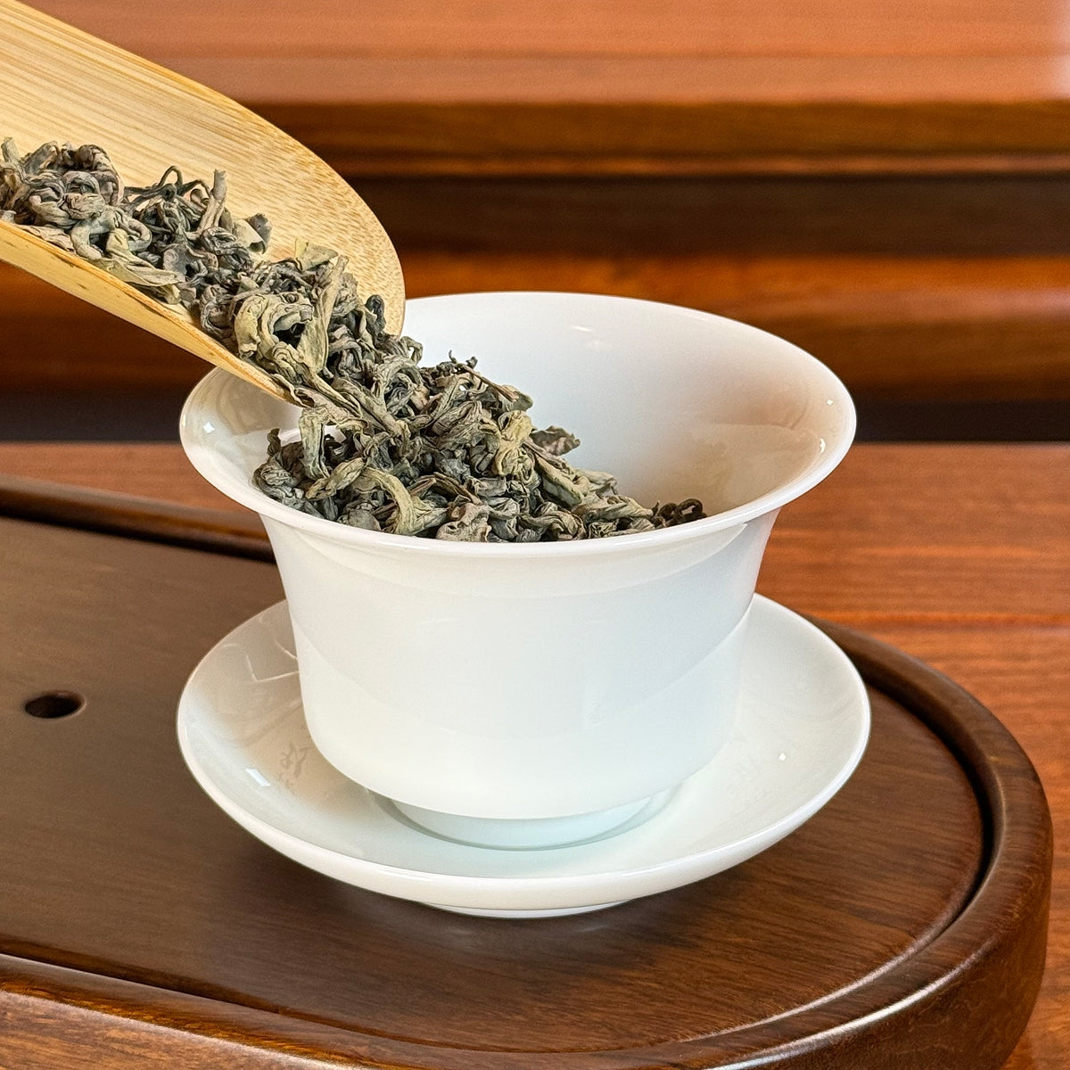 Rich Loose Leaf Green Tea Spring Harvest being prepared for brewing with Chinese food