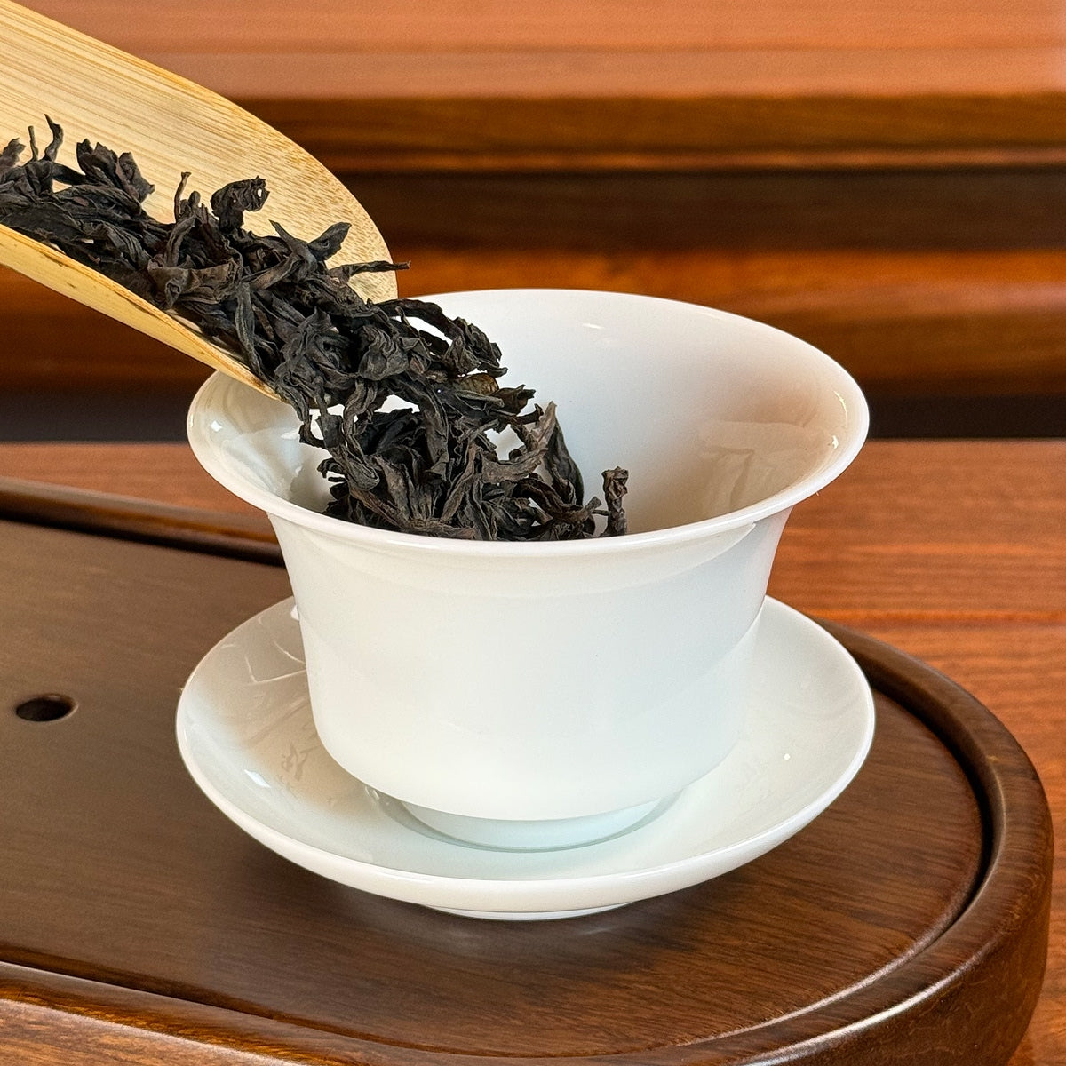Rou Gui Oolong Tea (Cinnamon) Wuyi Rock Tea dry leaves poured into traditional tea ware