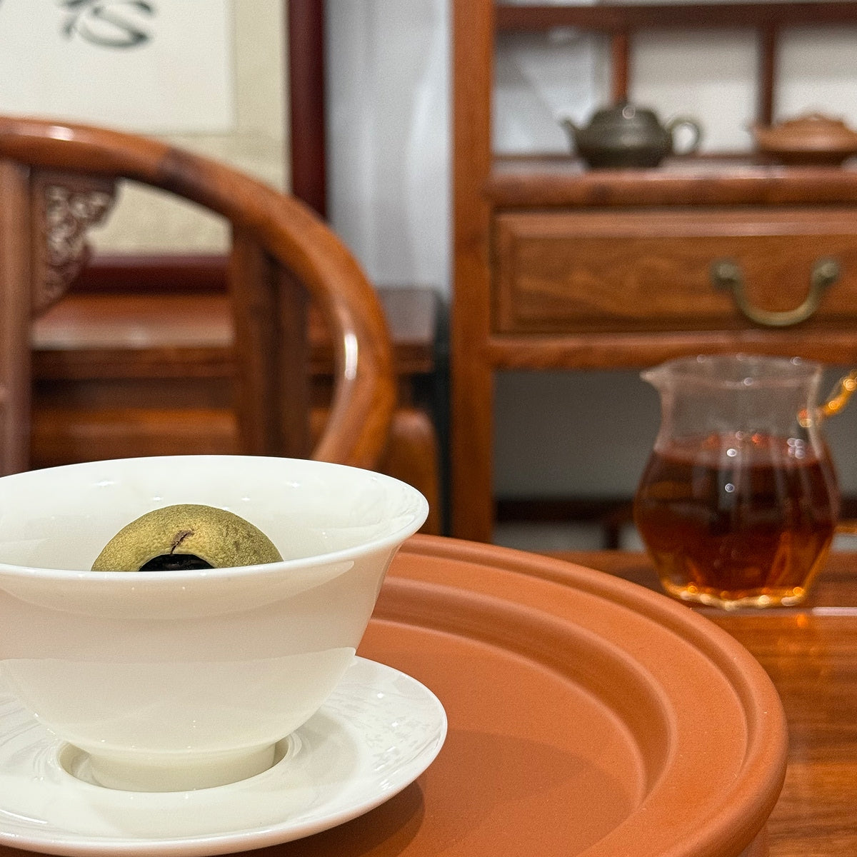 Brewed Tangerine Pu-erh Tea (Xiao Qing Gan) showing tea and infused tangerine