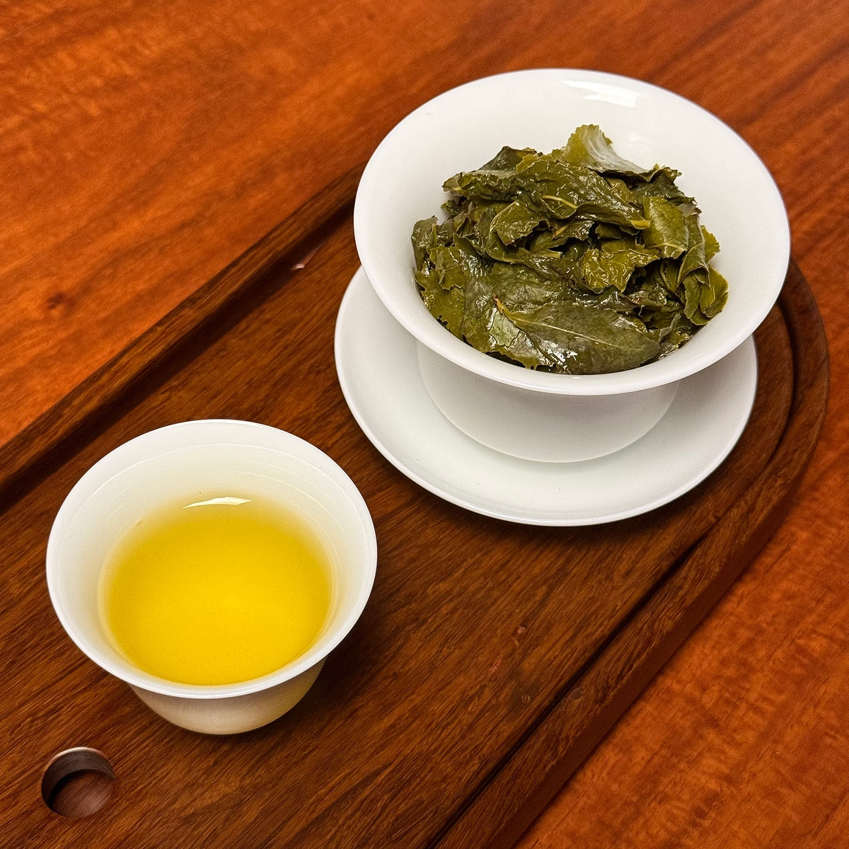 Tie Guan Yin Tea (Ti Kuan Yin / Iron Goddess) brewed oolong tea liquor showing amber color and clarity
