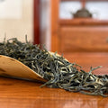 Xin Yang Mao Jian Green Tea (Green Tip Tea) dry leaves close-up in Chinese Tea Group tea house