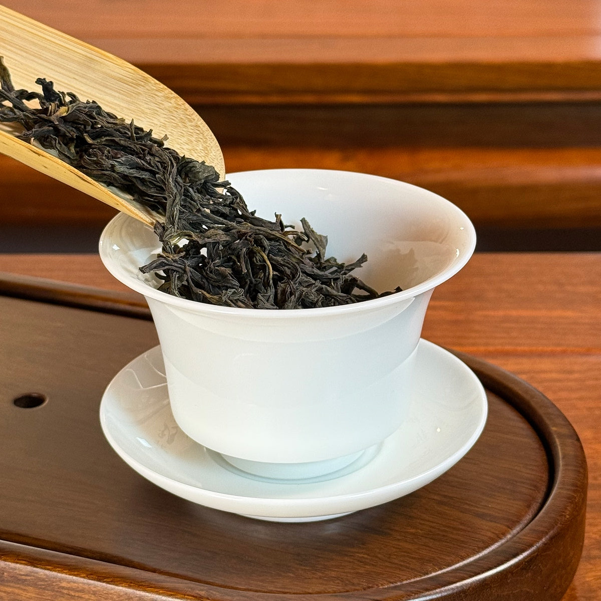 Ya Shi Xiang Dan Cong Tea (Duck Shit Aroma) dry leaves poured into teapot, from Chaozhou origin, releasing aroma