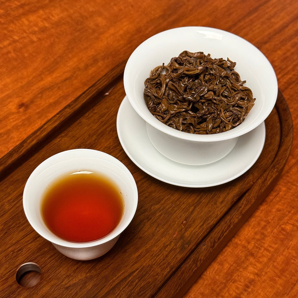Yunnan Golden Snail Black Tea (Dian Hong Jin Luo) brewed loose tea liquor showing amber color and clarity
