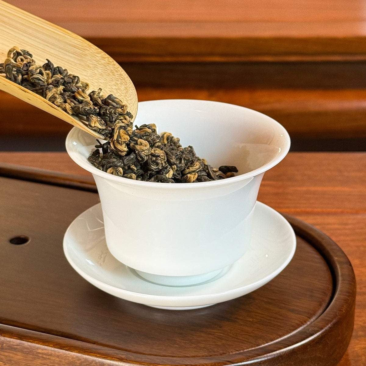 Yunnan Golden Snail Black Tea (Dian Hong Jin Luo) dry leaves poured into gaiwan for brewing